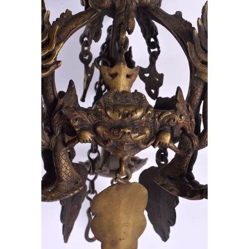 1867 - A RARE 19TH CENTURY INDIAN TIBETAN BRONZE HANGING BUDDHISTIC OIL BURNER formed with dragons and mask... 