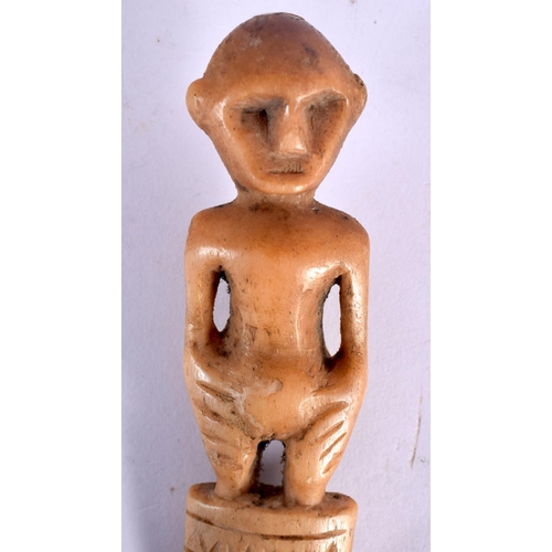 110 - A RARE 19TH CENTURY AFRICAN CARVED BONE TRIBAL COMB formed with a standing figure.18 cm long.