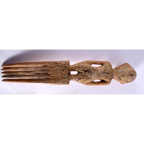 110 - A RARE 19TH CENTURY AFRICAN CARVED BONE TRIBAL COMB formed with a standing figure.18 cm long.