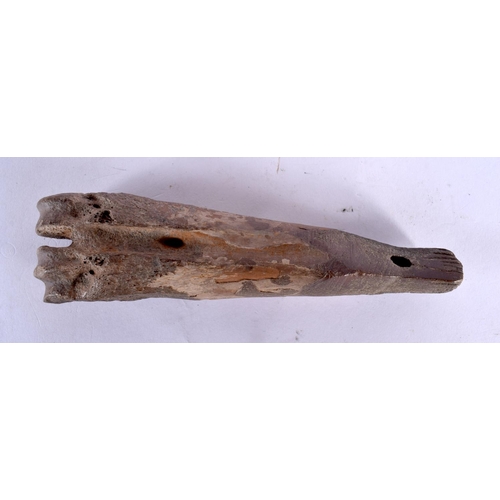 111 - A CHARMING PREHISTORIC FOSSILISED BONE CARVING of almost whale like form. 15 cm wide.