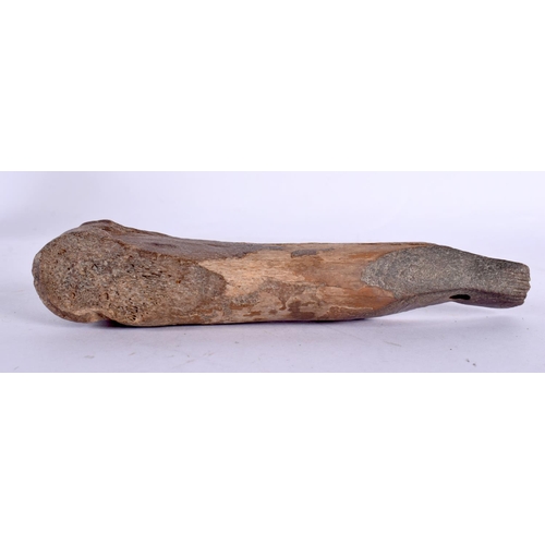 111 - A CHARMING PREHISTORIC FOSSILISED BONE CARVING of almost whale like form. 15 cm wide.