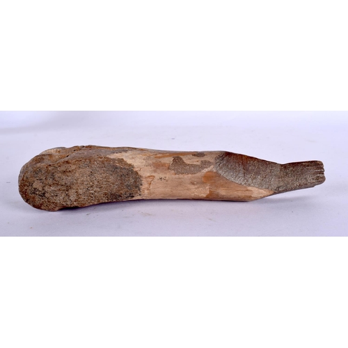 111 - A CHARMING PREHISTORIC FOSSILISED BONE CARVING of almost whale like form. 15 cm wide.