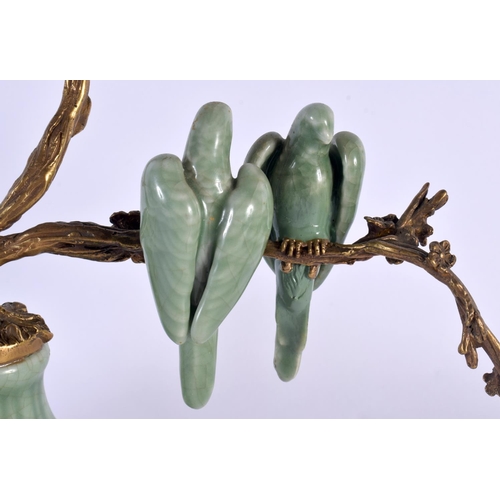 158 - AN UNUSUAL CONTINENTAL CELADON GLAZED COUNTRY HOUSE BRONZE CANDLESTICK overlaid with birds. 34 cm x ... 