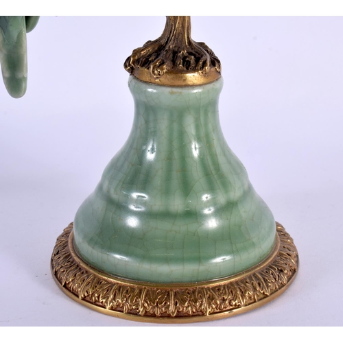 158 - AN UNUSUAL CONTINENTAL CELADON GLAZED COUNTRY HOUSE BRONZE CANDLESTICK overlaid with birds. 34 cm x ... 