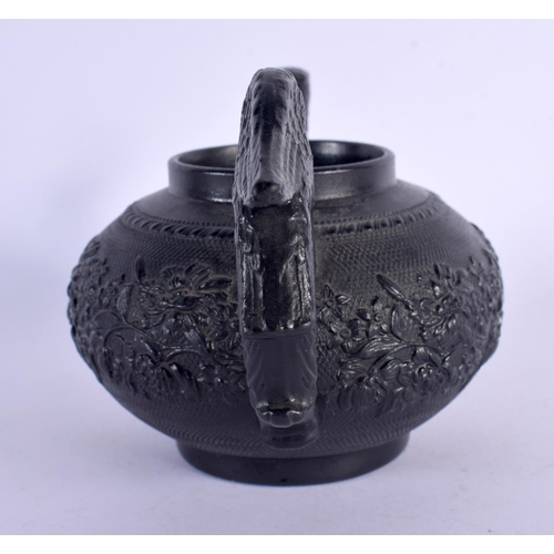 163 - AN EARLY 19TH CENTURY ENGLISH BLACK POTTERY TEAPOT decorated with foliage and vines. 17 cm wide.