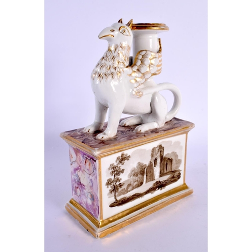 173 - 19th century English porcelain candlestick in the form of a griffin seated on a plinth, the plinth h... 