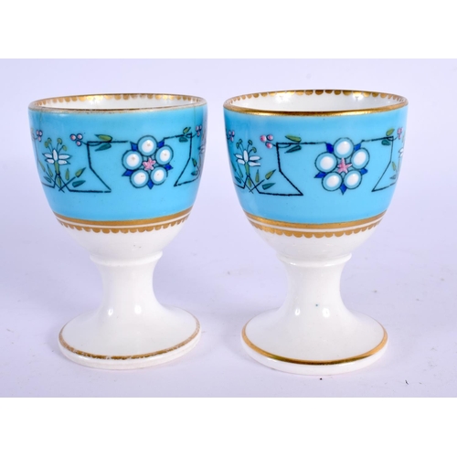 252 - Royal Worcester pair of egg cups decorated after Sir Christopher Dresser with a typical style on a t... 