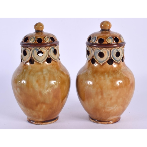 292 - A PAIR OF ROYAL DOULTON STONEWARE PEPPERETTES. 12 cm high.