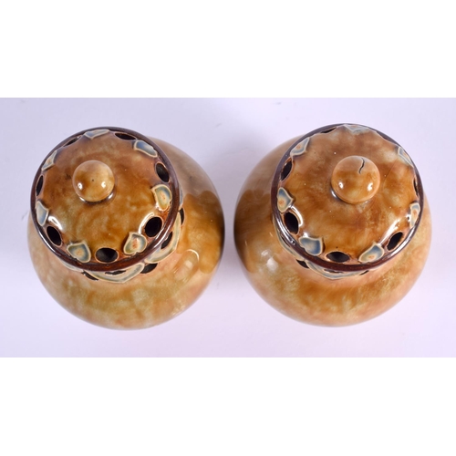 292 - A PAIR OF ROYAL DOULTON STONEWARE PEPPERETTES. 12 cm high.