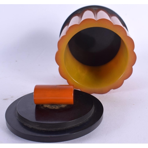301 - AN ART DECO ORANGE BAKELITE CATALIN JAR AND COVER. 127 grams. 8 cm x 6.5 cm.