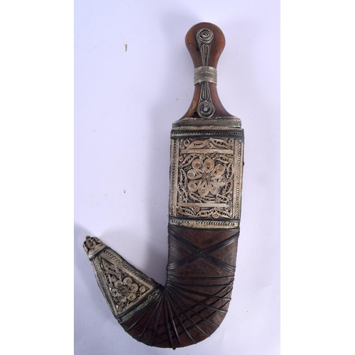 317 - AN ANTIQUE MIDDLE EASTERN YEMENI OMANI CARVED RHINOCEROS HORN JAMBIYA DAGGER with matching belt stra... 