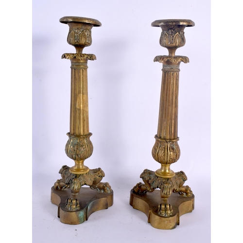 331 - A PAIR OF 19TH CENTURY FRENCH GILT BRONZE EMPIRE CANDLESTICKS with acanthus capped stems, supported ... 