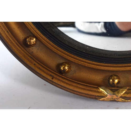 361 - A MINIATURE REGENCY STYLE GILT MIRROR. 16.5 cm diameter.