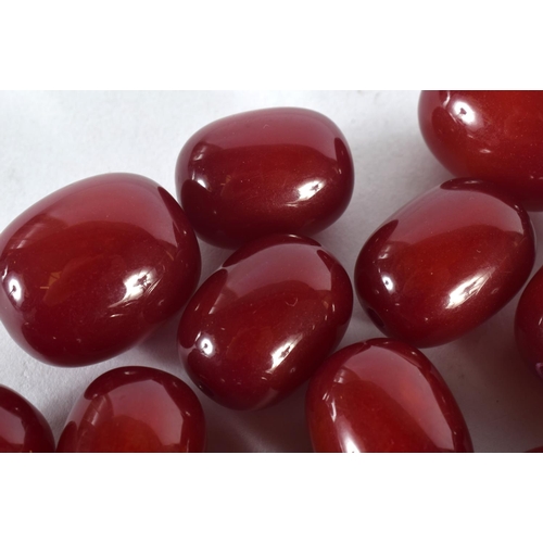 371 - A COLLECTION OF EUROPEAN ART DECO RED BEADS probably Faturan or cherry amber. 460 grams. Largest 3.5... 