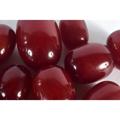 371 - A COLLECTION OF EUROPEAN ART DECO RED BEADS probably Faturan or cherry amber. 460 grams. Largest 3.5... 