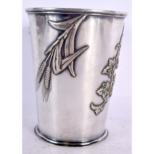 372 - AN AESTHETIC MOVEMENT SILVER PLATED BEAKER decorated with foliage. 12 cm x 9 cm.