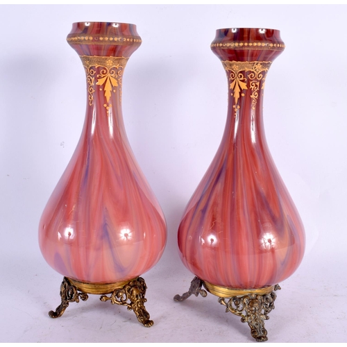 373 - A PAIR OF FINE EARLY 20TH CENTURY FRENCH MOTTLED GLASS VASES with gilt metal mask head mounts. 24.5 ... 