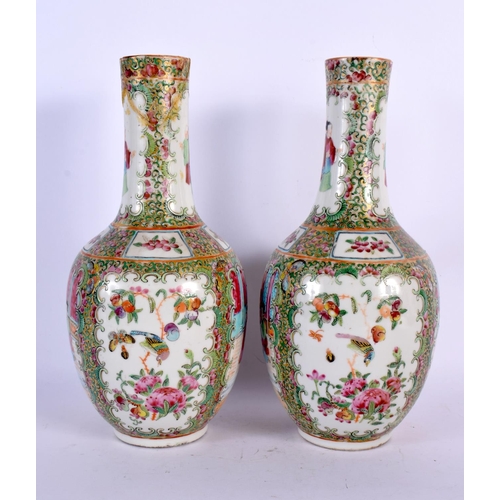 38 - A PAIR OF 19TH CENTURY CHINESE CANTON FAMILLE ROSE VASES painted with figures. 26 cm high.