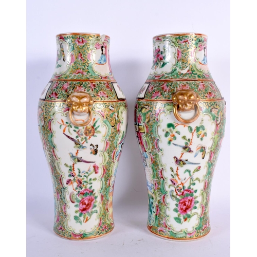 39 - A PAIR OF 19TH CENTURY CHINESE CANTON FAMILLE ROSE VASES painted with figures. 25.5 cm high.