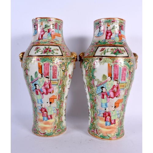 39 - A PAIR OF 19TH CENTURY CHINESE CANTON FAMILLE ROSE VASES painted with figures. 25.5 cm high.