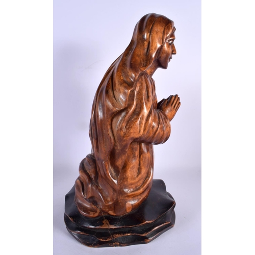 396 - A LATE 19TH CENTURY CONTINENTAL CARVED WOOD FIGURE OF A SAINT modelled with hands clasped. 40 cm x 1... 