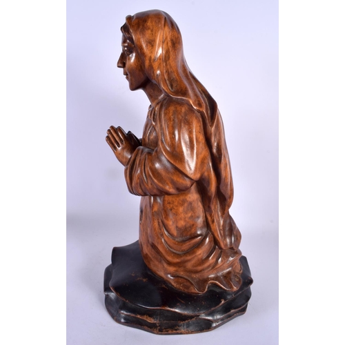 396 - A LATE 19TH CENTURY CONTINENTAL CARVED WOOD FIGURE OF A SAINT modelled with hands clasped. 40 cm x 1... 