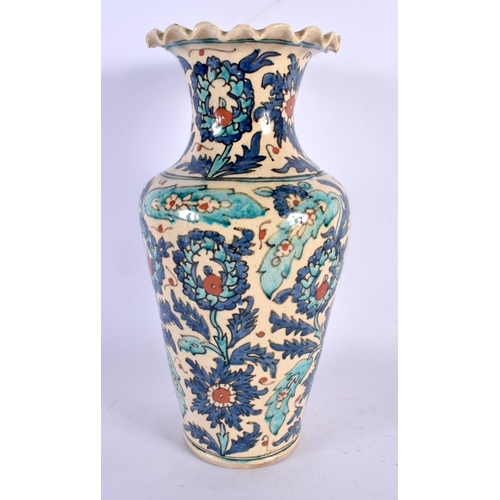 427 - A TURKISH MIDDLE EASTERN FAIENCE POTTERY VASE painted with flowers. 29 cm high.