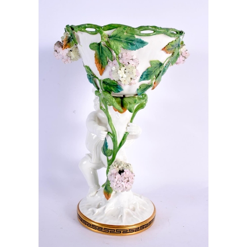 44 - A 19TH CENTURY ENGLISH MOORES POTTERY CHERUB VASE overlaid with foliage. 27 cm x 11 cm.