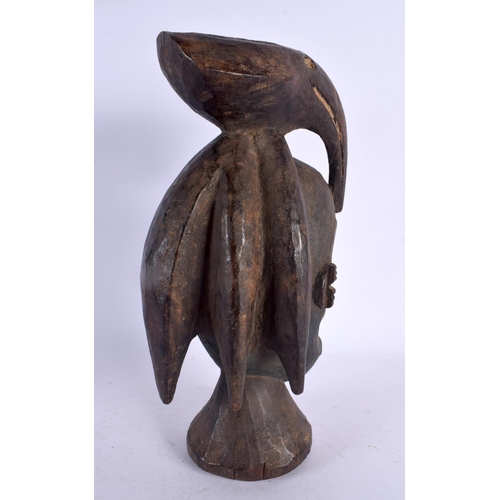 457 - AN AFRICAN TRIBAL CARVED BIRD OVERLAID MASK. 27 cm high.