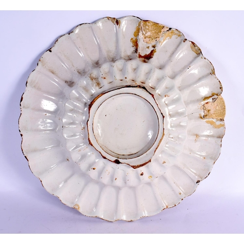 47 - A VERY RARE 17TH CENTURY DELFT TIN GLAZED SCALLOPED BOWL painted with a winged figure within a lands... 