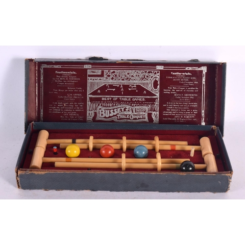 551 - A BOXED BUSSEYS TABLE CROQUET SET. 27 cm wide.