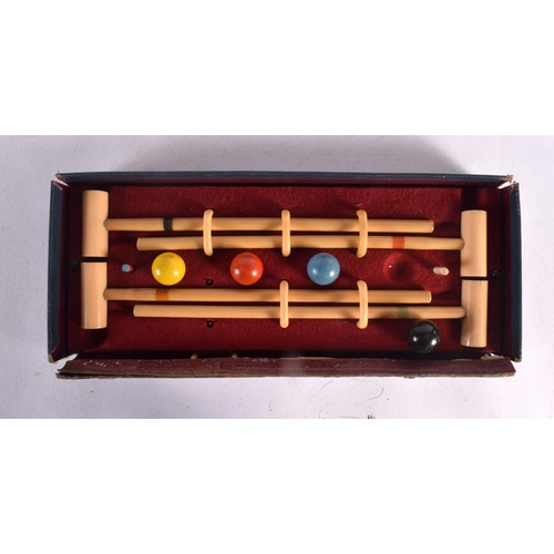 551 - A BOXED BUSSEYS TABLE CROQUET SET. 27 cm wide.