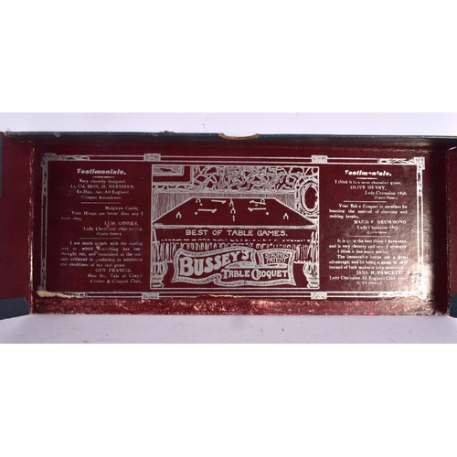 551 - A BOXED BUSSEYS TABLE CROQUET SET. 27 cm wide.