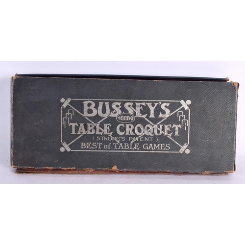 551 - A BOXED BUSSEYS TABLE CROQUET SET. 27 cm wide.