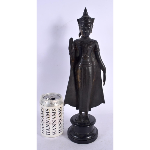 562 - A 19TH CENTURY SIAMESE BRONZE FIGURE OF A BUDDHA upon an ebonised base. 36 cm high.