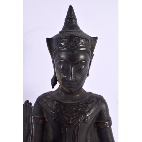 562 - A 19TH CENTURY SIAMESE BRONZE FIGURE OF A BUDDHA upon an ebonised base. 36 cm high.