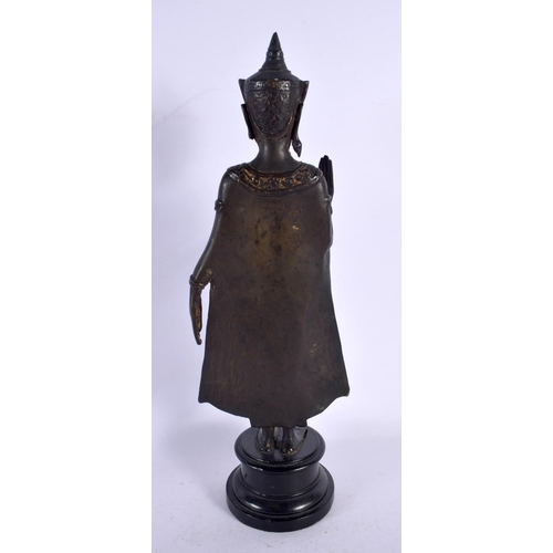 562 - A 19TH CENTURY SIAMESE BRONZE FIGURE OF A BUDDHA upon an ebonised base. 36 cm high.
