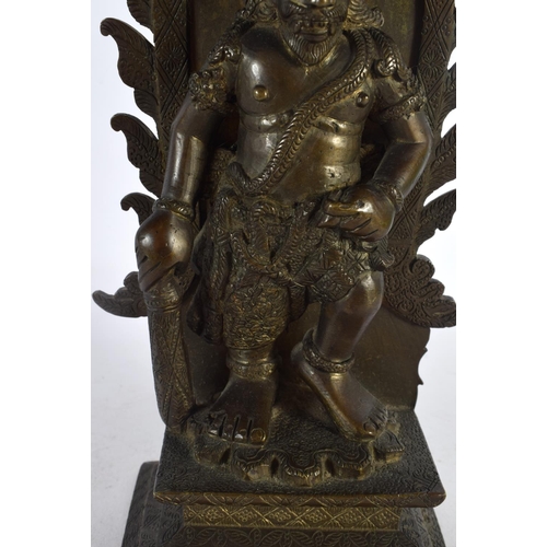 563 - A GOOD 19TH CENTURY INDIAN BRONZE FIGURE OF A STANDING BUDDHA modelled upon a rectangular base. 27 c... 