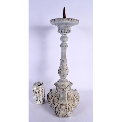 569 - A LARGE 18TH CENTURY CONTINENTAL BAROQUE PAINTED WOOD CANDLESTICK. 49 cm high.