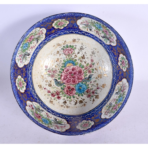 575 - A 19TH CENTURY MIDDLE EASTERN PERSIAN ENAMEL BOWL painted with flowers. 18 cm diameter.