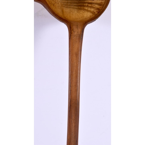 576 - A 19TH CENTURY MIDDLE EASTERN CARVED RHINOCEROS HORN LADLE. 40 cm high.