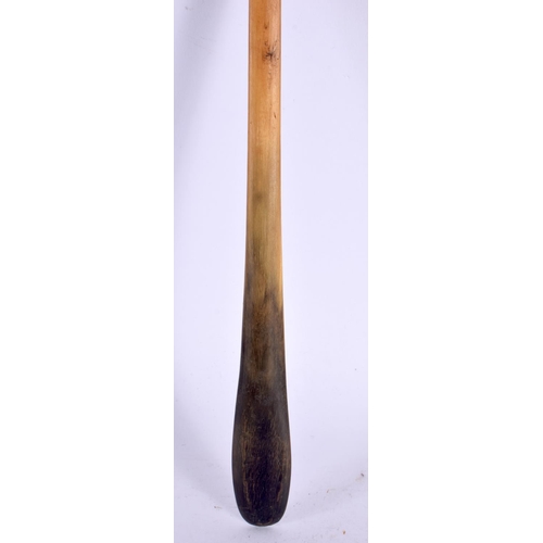 576 - A 19TH CENTURY MIDDLE EASTERN CARVED RHINOCEROS HORN LADLE. 40 cm high.