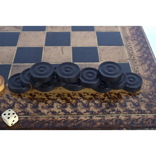 580 - AN ANTIQUE COUNTRY HOUSE FAUX BOOK LEATHER GAMING BOX with accompanying backgammon counters. Box 40 ... 