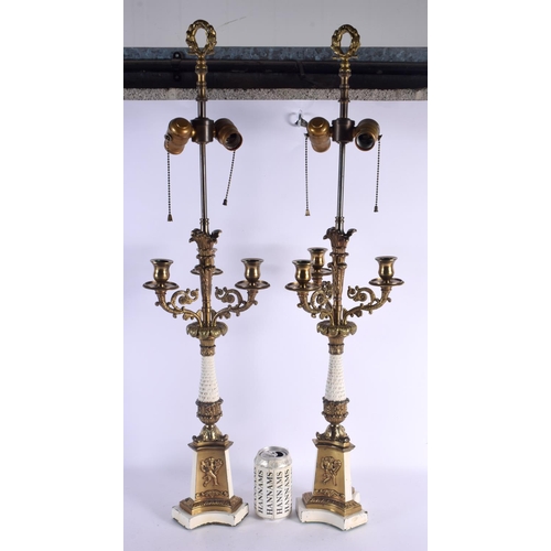 744 - A PAIR OF EARLY 20TH CENTURY BRONZE CANDLESTICKS decorated with putti. 68 cm high.