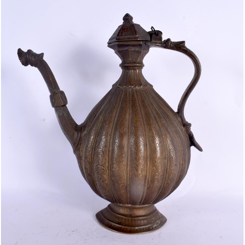 77 - A LARGE 18TH CENTURY MIDDLE EASTERN OTTOMAN TYPE BRONZE EWER decorated all over with foliage and vin... 