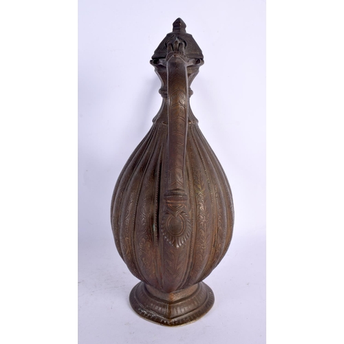 77 - A LARGE 18TH CENTURY MIDDLE EASTERN OTTOMAN TYPE BRONZE EWER decorated all over with foliage and vin... 