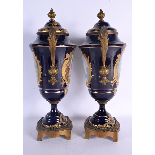 88 - A LARGE PAIR OF 19TH CENTURY FRENCH SEVRES PORCELAIN VASES AND COVERS painted with figures in landsc... 