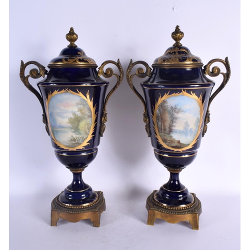 88 - A LARGE PAIR OF 19TH CENTURY FRENCH SEVRES PORCELAIN VASES AND COVERS painted with figures in landsc... 