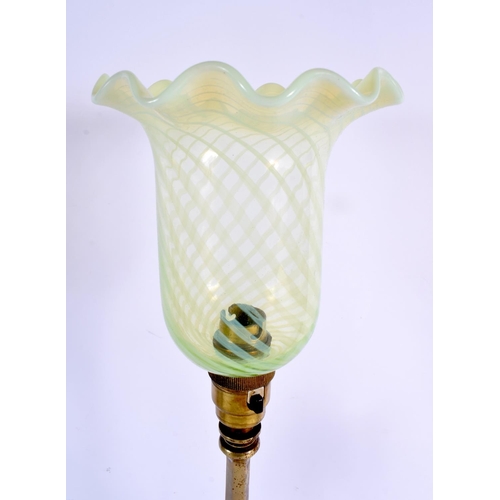 90 - TWO ART NOUVEAU BRASS CANDLESTICKS one with vaseline glass lamp fittings. Largest 47 cm high. (2)