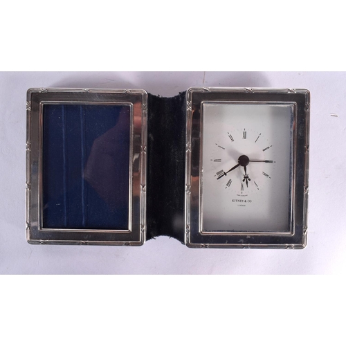 99 - THREE SILVER MOUNTED PHOTOGRAPH FRAMES together with two silver clocks. London 1921, 1970 & 1995. 67... 